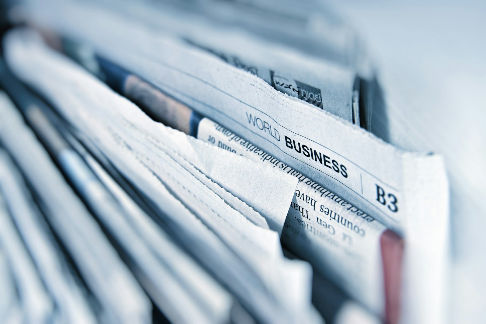 A stack of folded newspapers with World Business B3 visible on the spine
